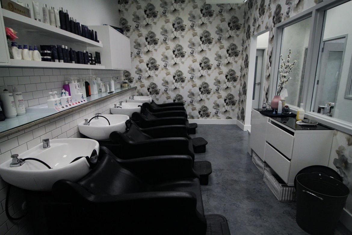 hair wash stations with black chairs