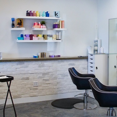 black salon chair and products on shelf
